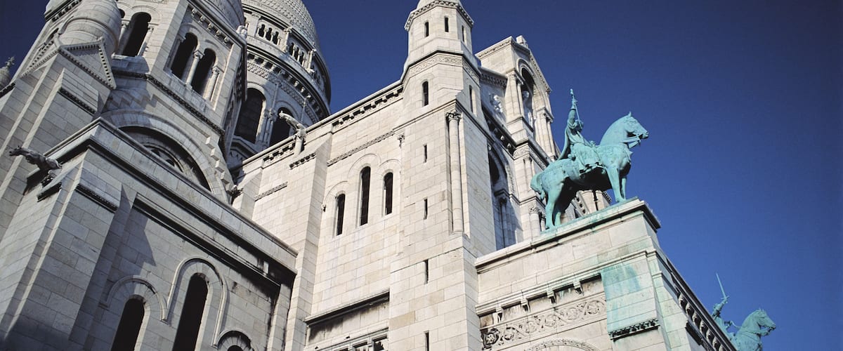 A historic building with domed architecture and statues.