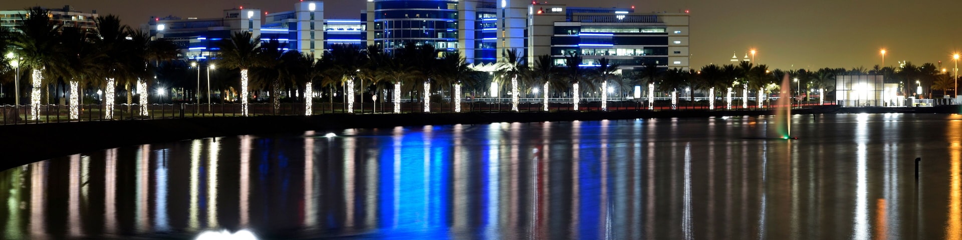 Dubai, United Arab Emirates - May 21, 2018: Dubai Silicon Oasis Headquarters Building with Lake view at night, Established in 2014 a free zone owned by the Government of Dubai.