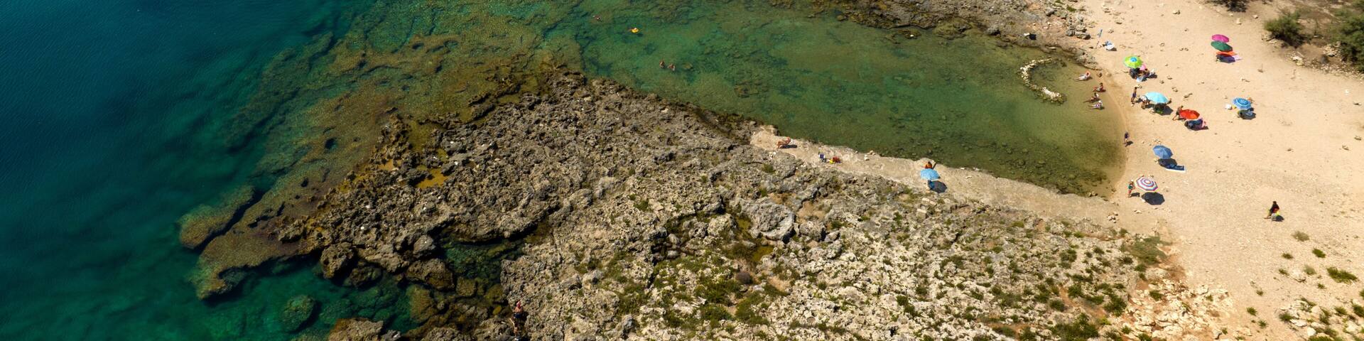 Aerial view of the rocky beach of Serra Cicoria, in the municipality of Nardò, in the Province of Lecce, Puglia, Italy. It is a pristine coast of Salento.