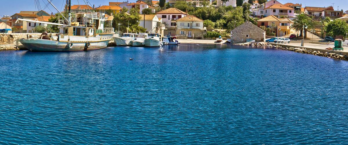 A harbor with boats, a church, and residential buildings.