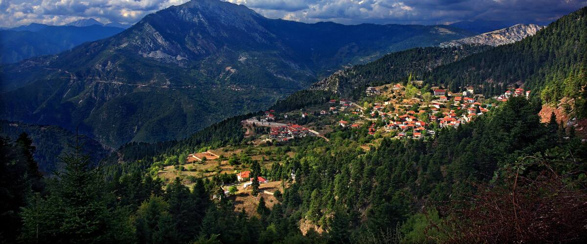 A mountainous landscape with a village nestled among the hills.