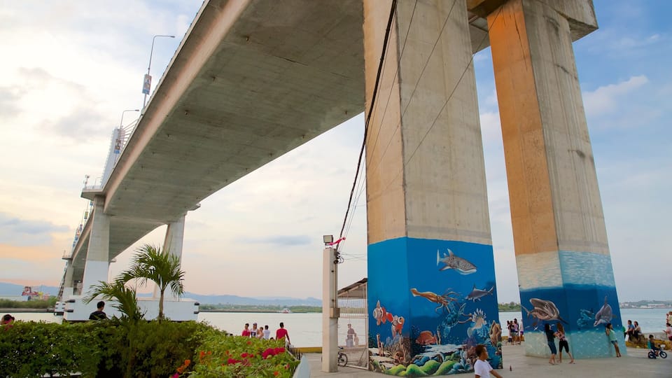 A bridge with a mural of marine life on its pillars.
