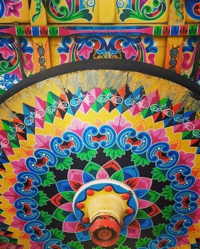 A colorful, intricately designed ceiling with geometric patterns and floral motifs.