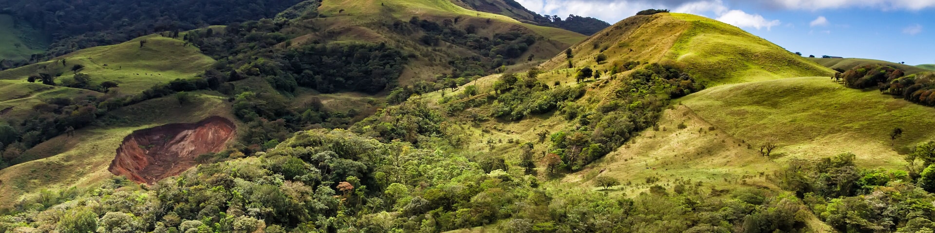 Monteverde, Santa Elena and Arenal area in Costa Rica highlands. Panoramic view in sunny day of a vast hills and mountains in this pristine region of Central America