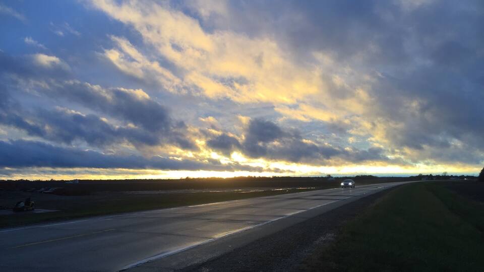 A highway with a sunset sky.