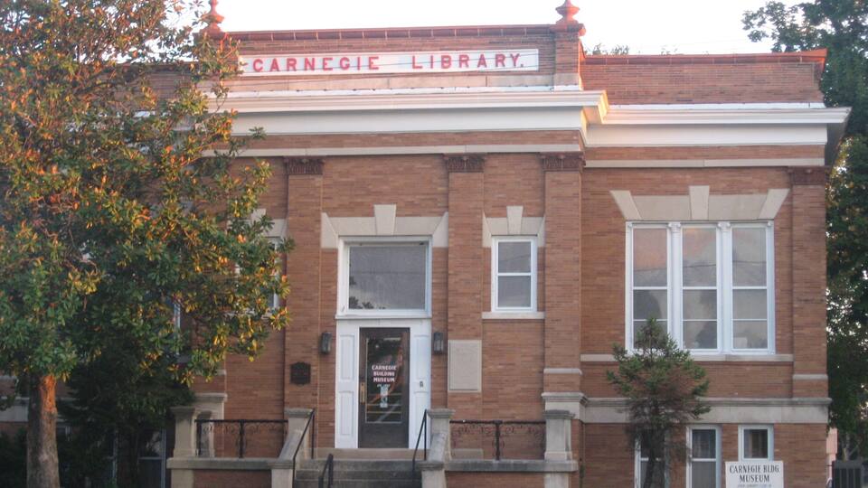 A brick building with a sign reading "Carnegie Library."