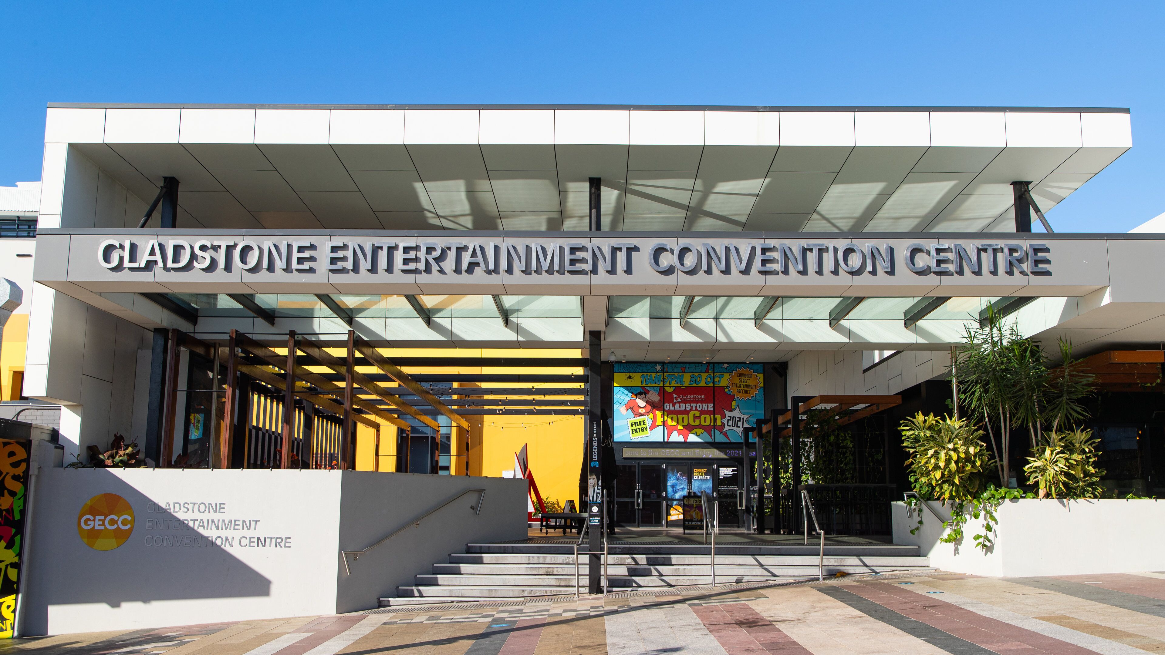 The entrance to Gladstone Entertainment Convention Centre with a clear sign, steps, and a sheltered entrance area.