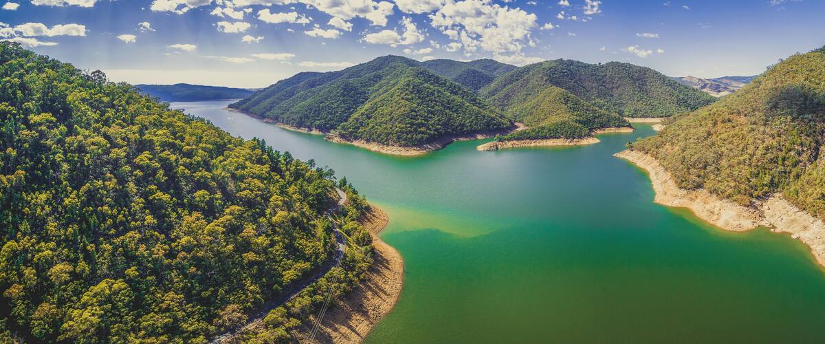 A lake surrounded by forested hills.