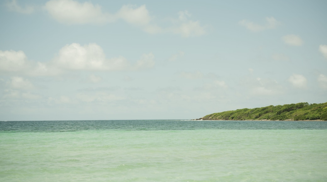 Turquoise waters and distant green coastline at Playa La Chiva