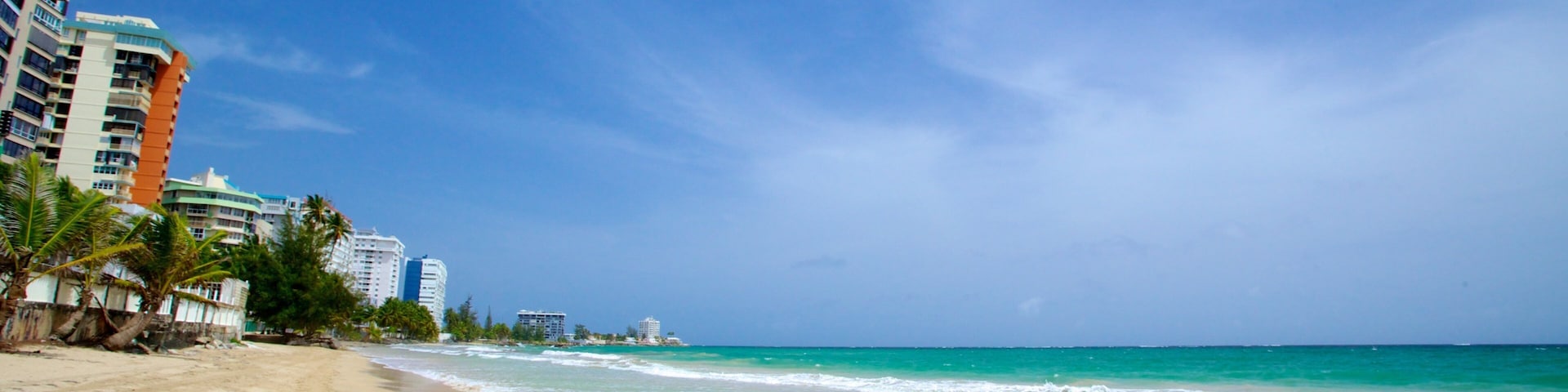 Isla Verde Beach showing a beach and a coastal town