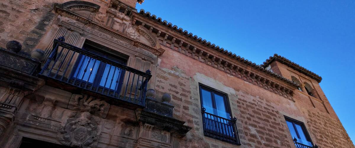 A historic building with ornate balconies and detailed stonework.
