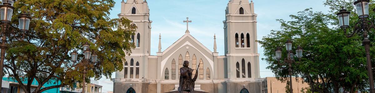 Statue of Christopher Columbus and an ancient church at the square of Aguada, Puerto Rico