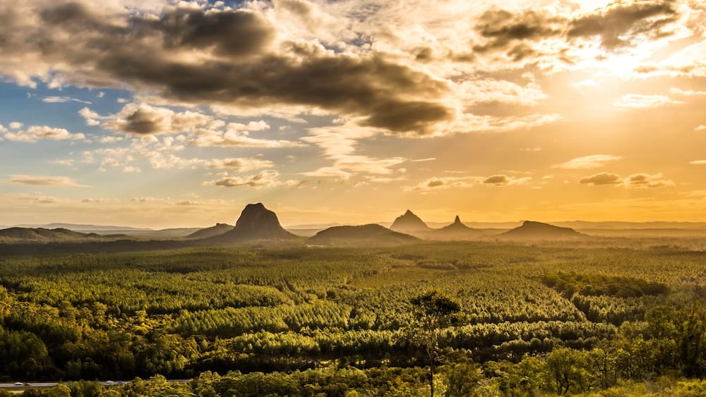 Panoramic view of Glass House Mountains at sunset visible from Wild Horse Mountain Lookout