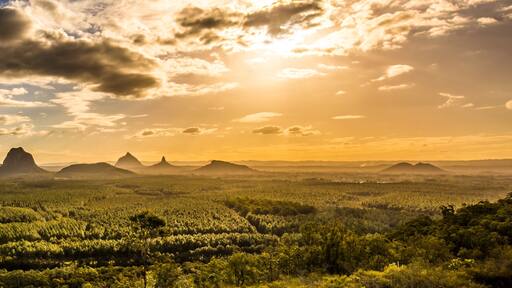 Panoramic view of Glass House Mountains at sunset visible from Wild Horse Mountain Lookout