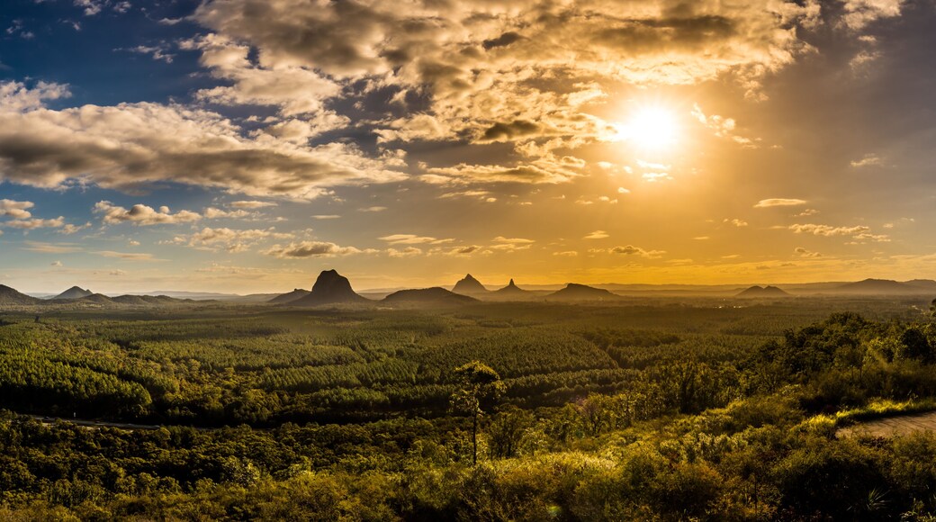 Panoramic view of Glass House Mountains at sunset visible from Wild Horse Mountain Lookout