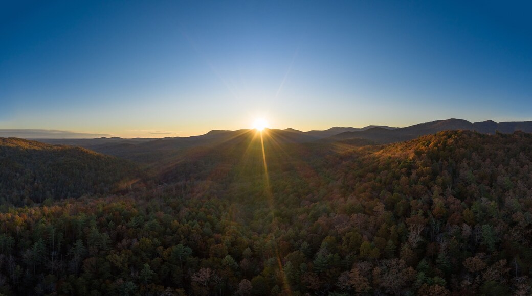 Aerial panoramic view of sunset with sun rays in Georgia Mountains during the fall