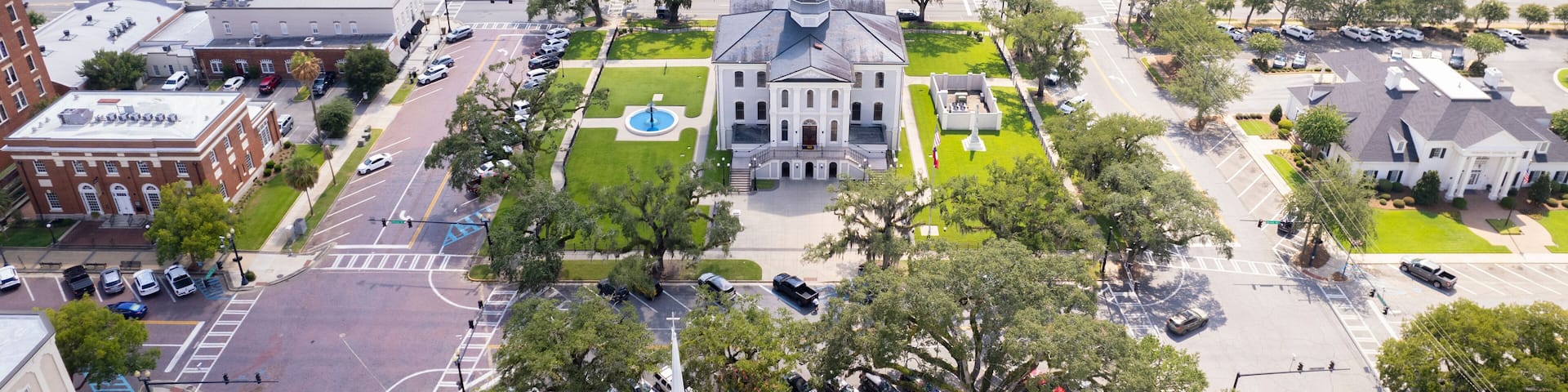 Aerial view of beautiful courthouse surrounded by greenery and historic buildings in downtown Thomasville, Georgia, United States.