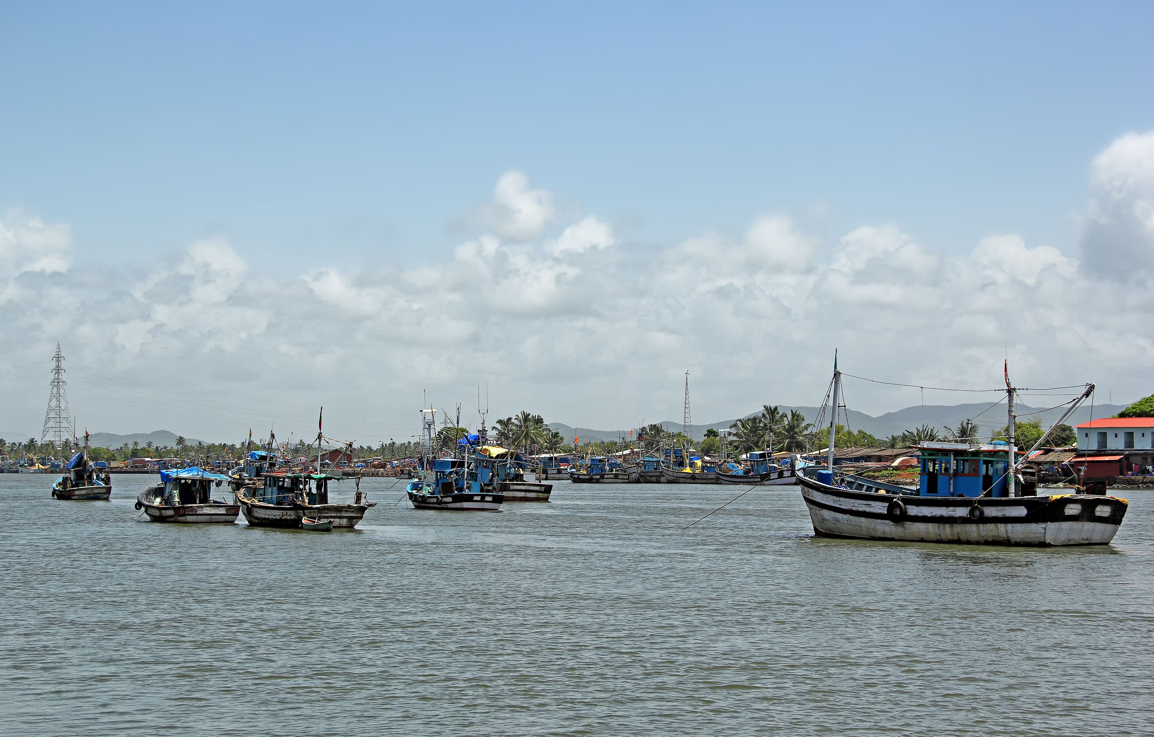 Anchored fishing boats at Cutbon Fishing Jetty, at the mouth of Sal River, adjacent to Cutbona Jetty in Goa, viewed from Betul.