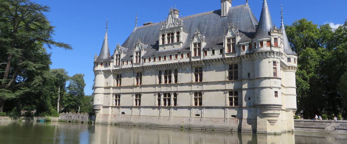 A large, historic castle with multiple towers and a moat.