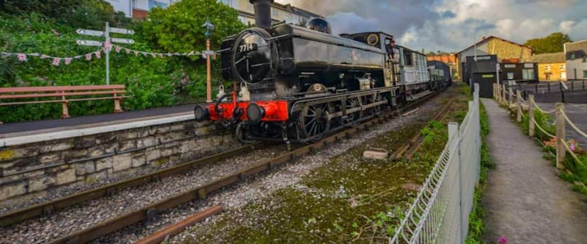Gala day on the West Somerset Railway and an early morning steam hauled goods train passes Watchet station.