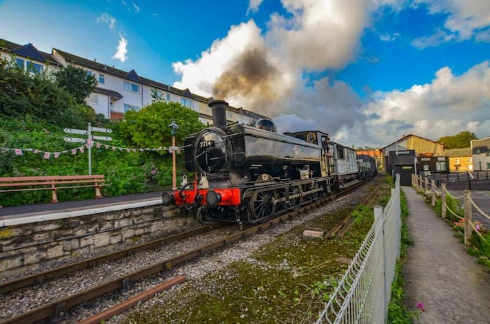 Gala day on the West Somerset Railway and an early morning steam hauled goods train passes Watchet station.