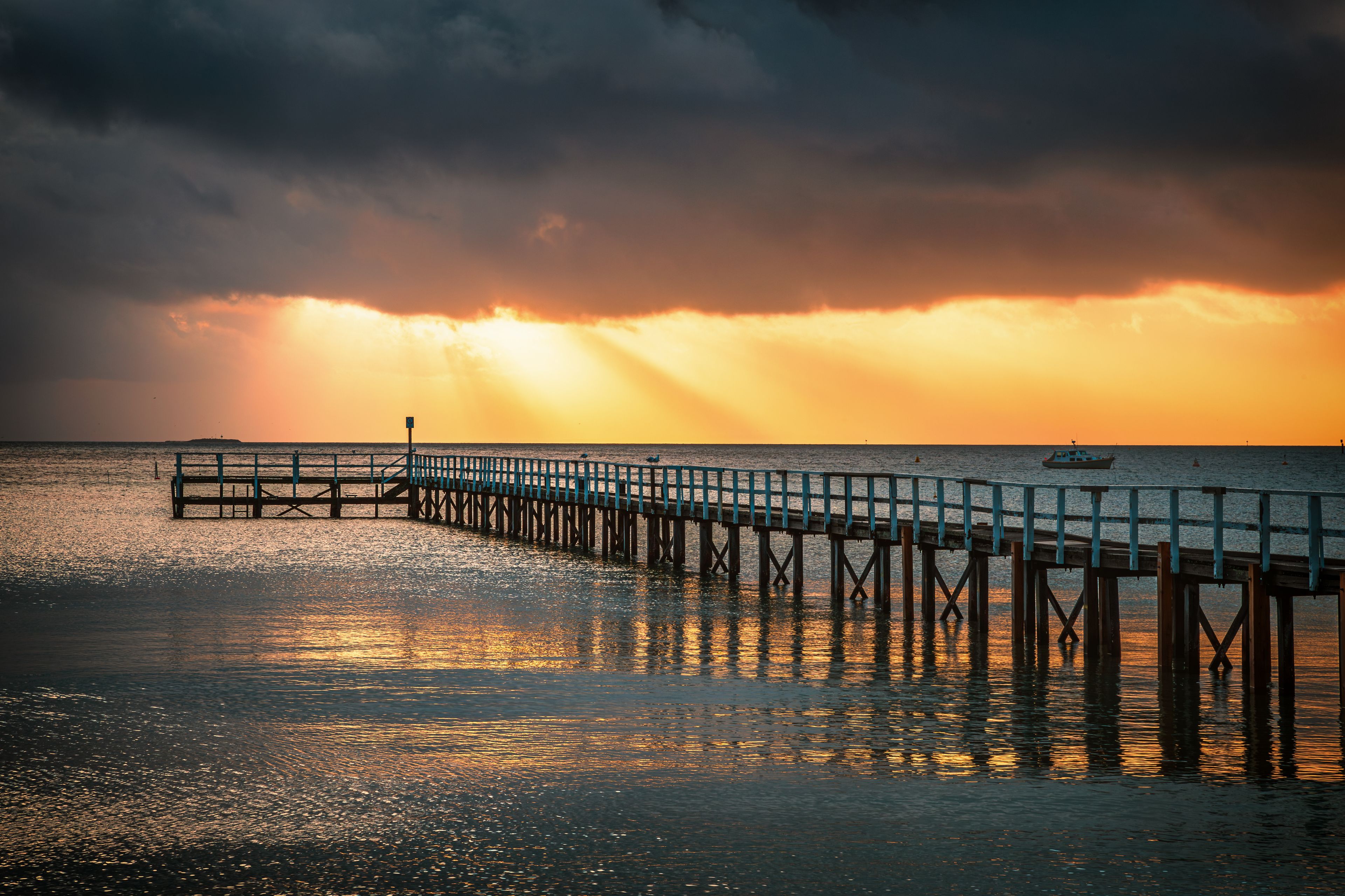 The view of the Sorrento Long Pier in Mornington Peninsula in Melbourne under the sunbeam at dawn 