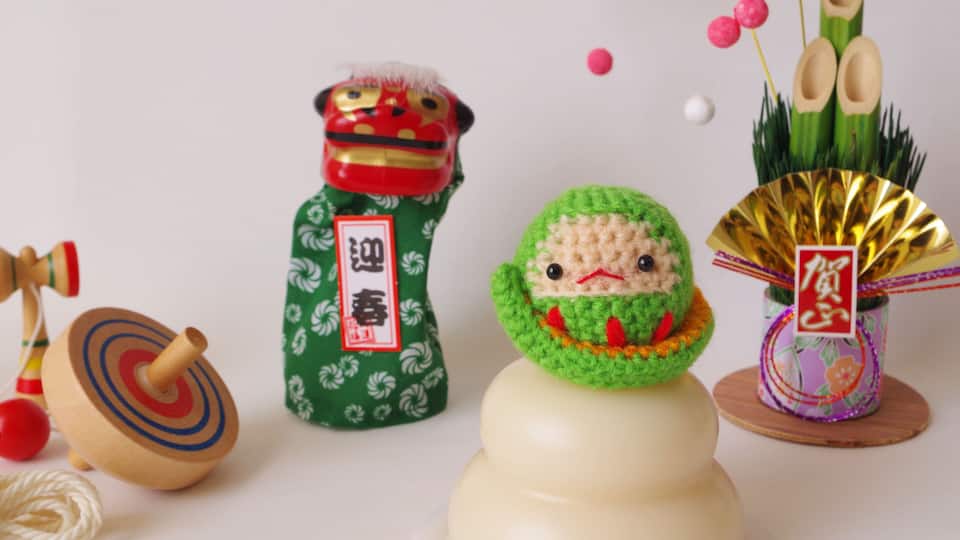 A traditional Chinese New Year decoration with a lion head, a green dragon, and a fan.