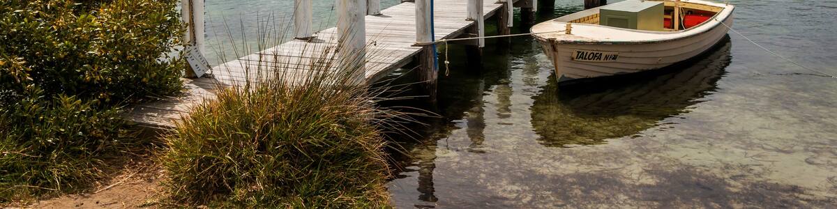 a small boat and wharf in a body of water