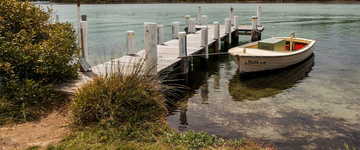 a small boat and wharf in a body of water