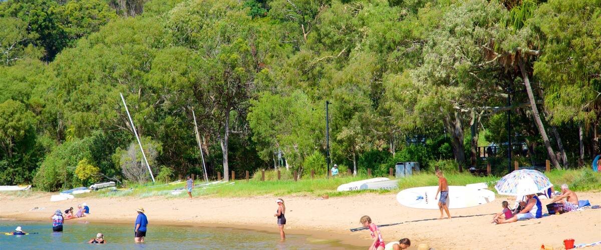 A beach with people swimming and relaxing.