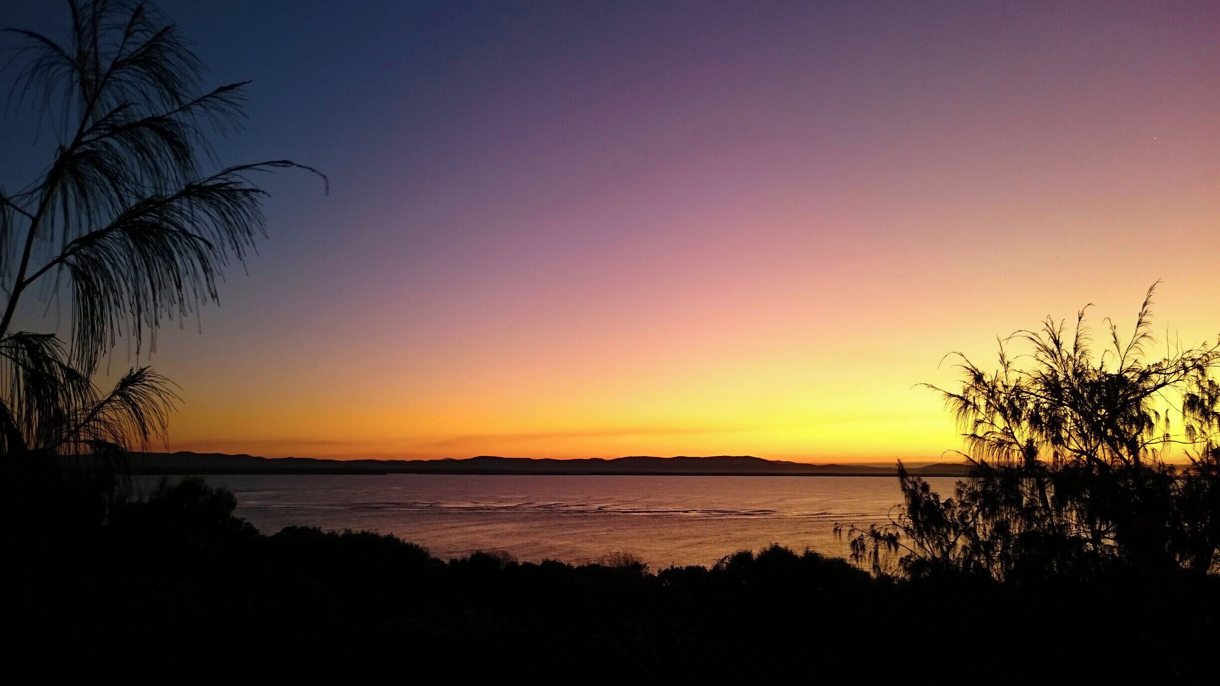 From the lookout at Seventeen Seventy you can see the moon rise on one side of you, and simultaneously see the sunset on the other.... and what a sunset it is too. 

To reach the lookout, follow the (only) road through the township of Seventeen Seventy and up the hill. When you reach the x intersection, turn left and follow to the carpark. From the carpark you can see the moos rise and sunset, and take a few short walks around this magnificent headland. 

#Colorful #roadtrip