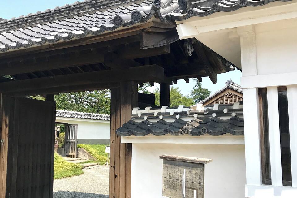 A traditional Japanese building with a tiled roof and wooden beams.
