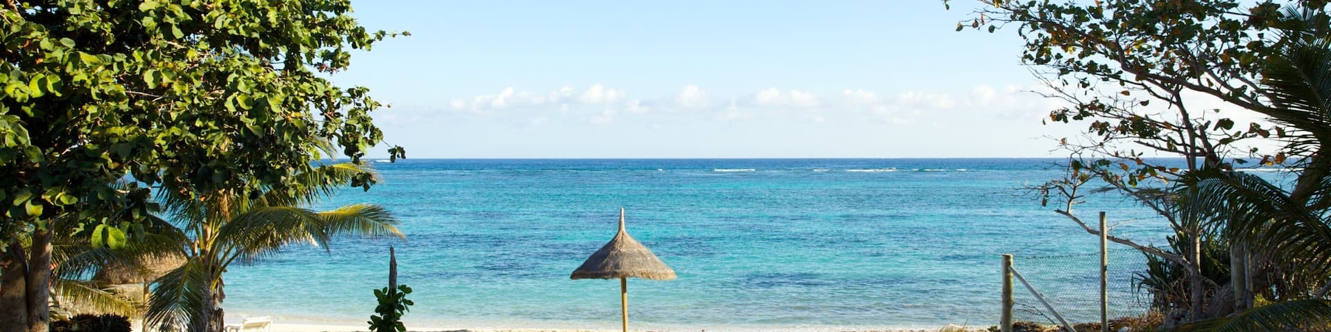 Stunning view of Viwa Island's beach and clear ocean waters in Fiji, showcasing tropical beauty and tranquility