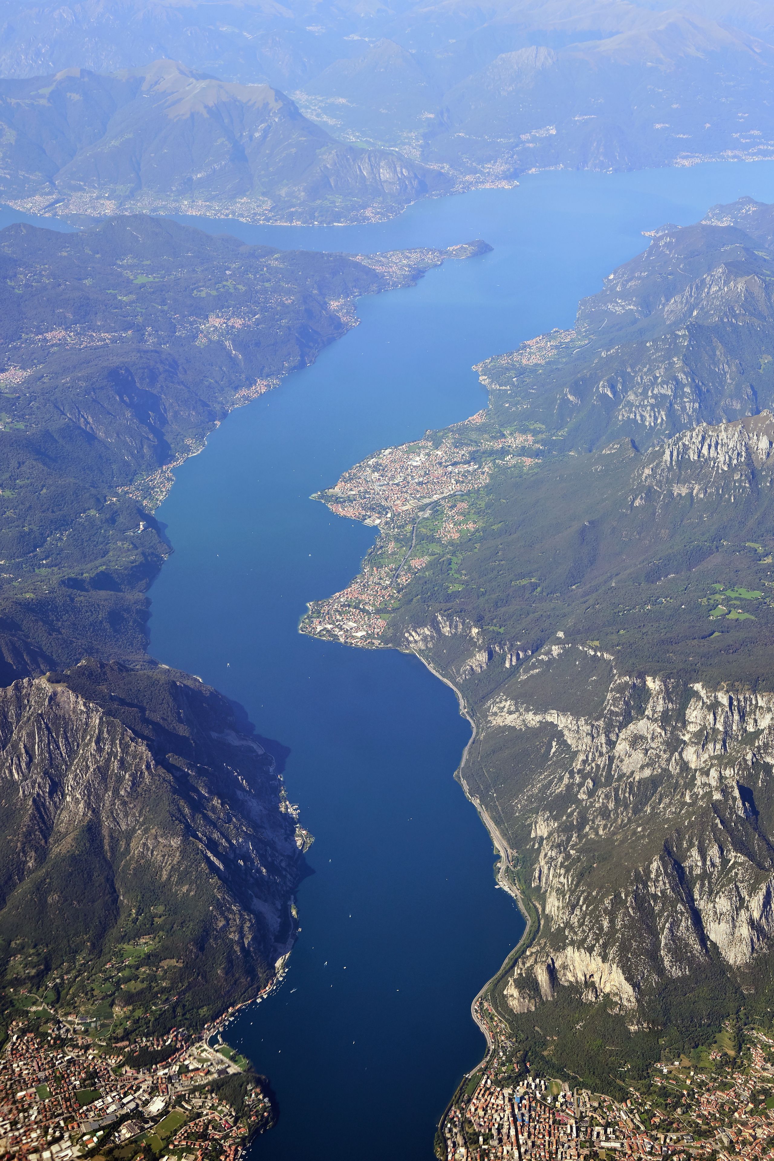 A river winding through a mountainous landscape with a town along the riverbanks.