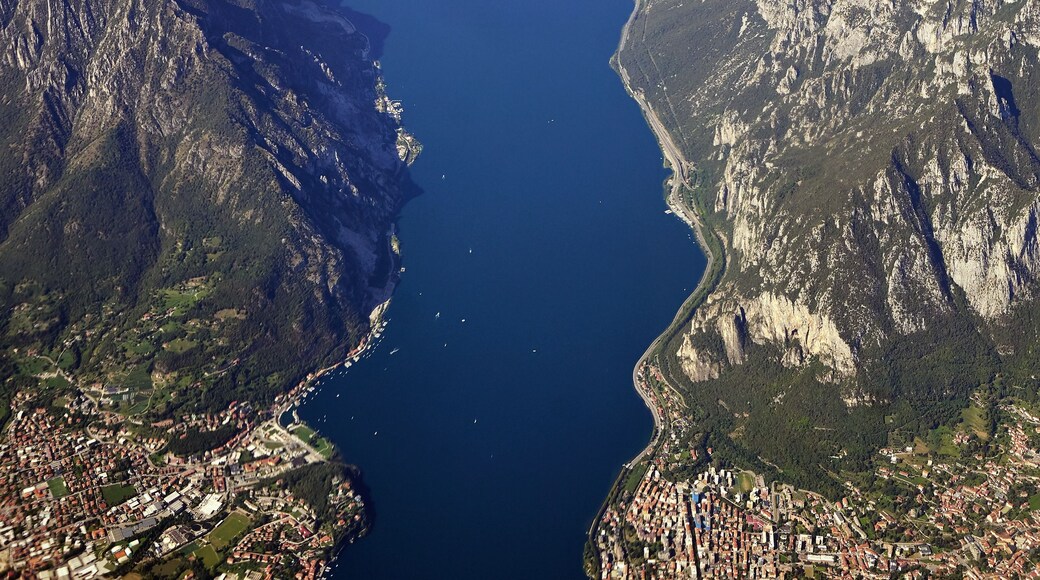 A river winding through a mountainous landscape with a town along the riverbanks.