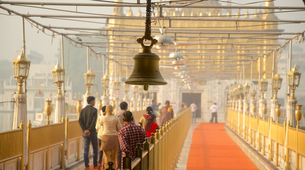 Durgiana Temple showing heritage elements and a temple or place of worship as well as a small group of people