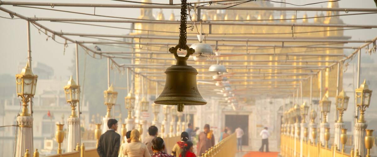 Durgiana Temple showing heritage elements and a temple or place of worship as well as a small group of people