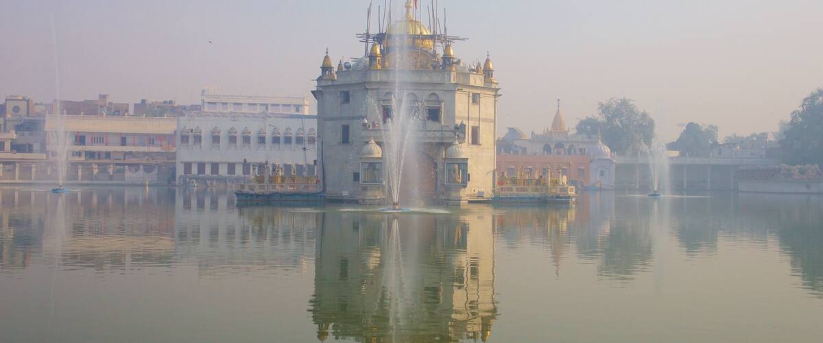 Durgiana Temple showing a temple or place of worship, heritage elements and a lake or waterhole