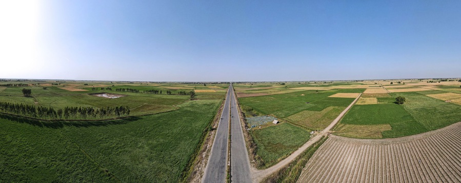 A 180 degree panorama of long road leading to District Narowal of Punjab province. It was captured with a drone amid wheat fields and honey bee farms