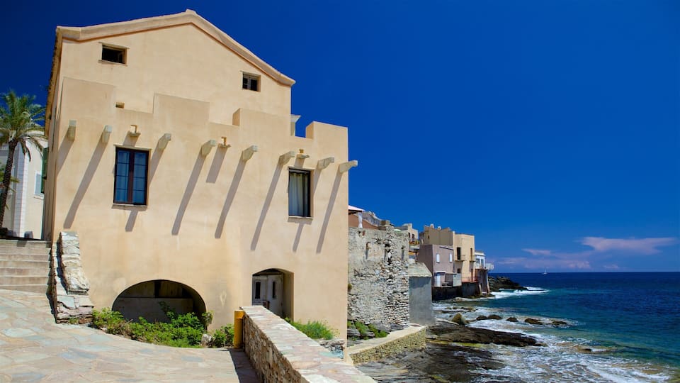 A coastal building with a stone staircase and a view of the ocean.
