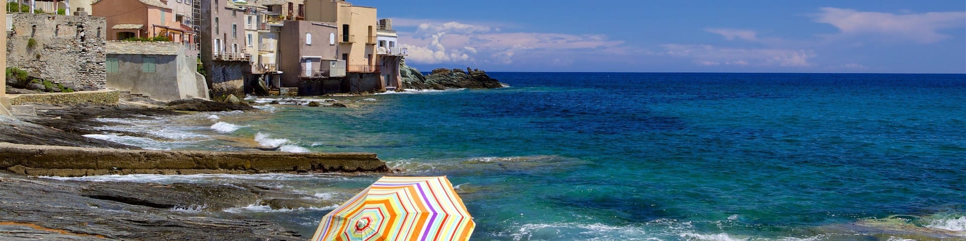 Brando featuring a coastal town and rocky coastline