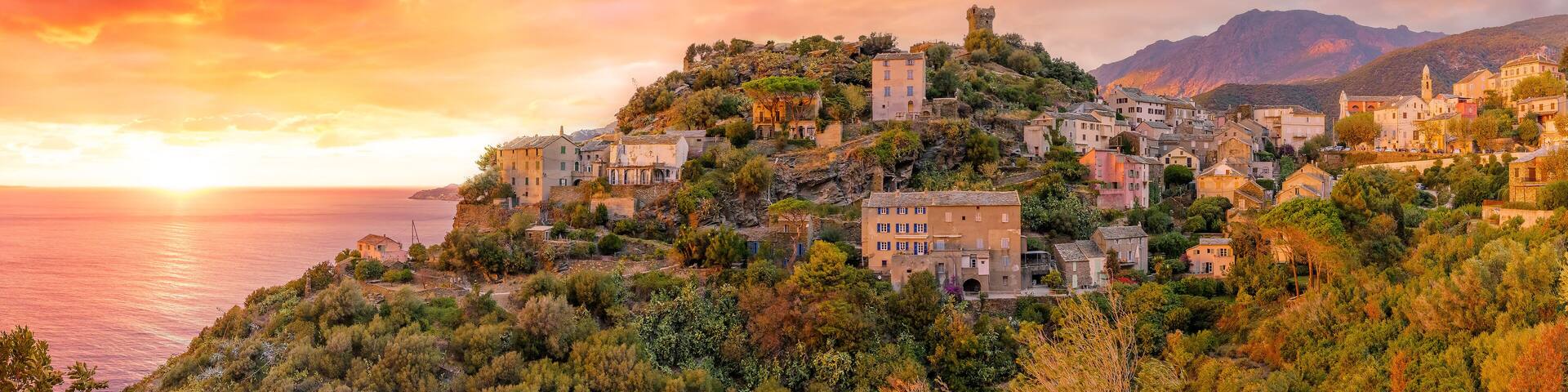 Landscape with Nonza village at sunset time, Corsica island, France