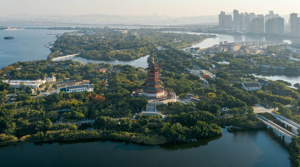 Aerial view of Xiamen Yuanboyuan, Expo garden scenic area with lakes and city skyline at dusk