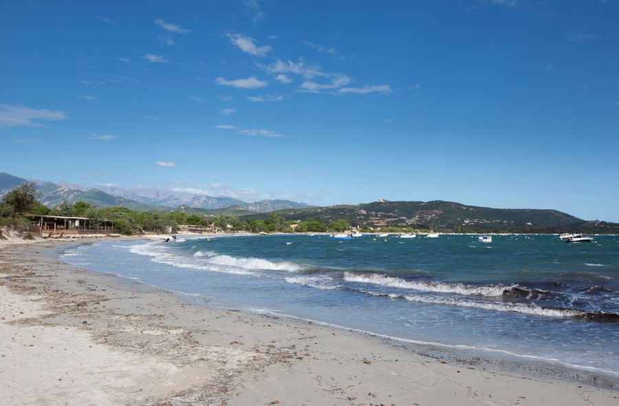 Dramatic view of San Cirprianu Beach in Lecci, Corsica, France on a stormy day with rough seas and waves and a big blue sky with fluffy clouds; Shutterstock ID 1244169700; Purchase Order: -