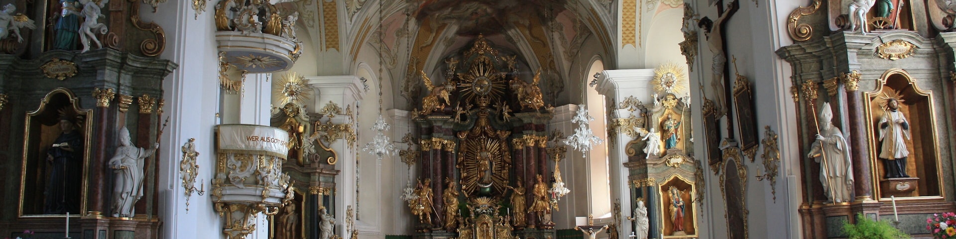 Italy, South Tyrol, Gossensaß. The church is dedicated to the Immaculate Conception and was built in 1750 on the same place of the old gothic church erected in 1471 and dedicated to Saint George of which remains the bell tower. The church was built on design of Franz de Paula Penz in baroque, it is possible a former project by Johann G. D. Grasmair. The church was consecrated on July 4 and 5, 1754 by bishop Leopold von Spaur. The front shows the portal of the old church and the three niches in which are placed the statues of the Immaculate Conception, Joachim and Saint Anne. The nave has a cross shape with two arms forming four lateral chapels. The high altar is rich in golden shades and at the centre of the throne is placed the statute of the Immaculate with the child. To the left side, between the two lateral chapels, is the baroque pulpit of 1777 positioned in a central site. To the right side between the two lateral chapels is a Crucifix by Bartlmä Kleinhans. The first right lateral altar is dedicated to Our Lady of Sorrows encircled by the statues of Mary Magdalene, Saint Elisabeth and Saint James works of 1750. The second right lateral altar is dedicated to Francis Xavier and two Bishops: Saint Ingenuinus and Saint Albuin coming from the old Saint George church. The first left lateral altar is the Flagellation of Christ at the column and the Saints Peter and John on each side. To the second left lateral altar is Saint Leonard, by side are the statues of Saint Sylvester, Saint Gregory and Saint Barbara coming from the old church. The eastern dome fresco was painted by Matthäus Günther and represents the Christ crowning Mary and Saint George throwing the pierced dragon downwards.