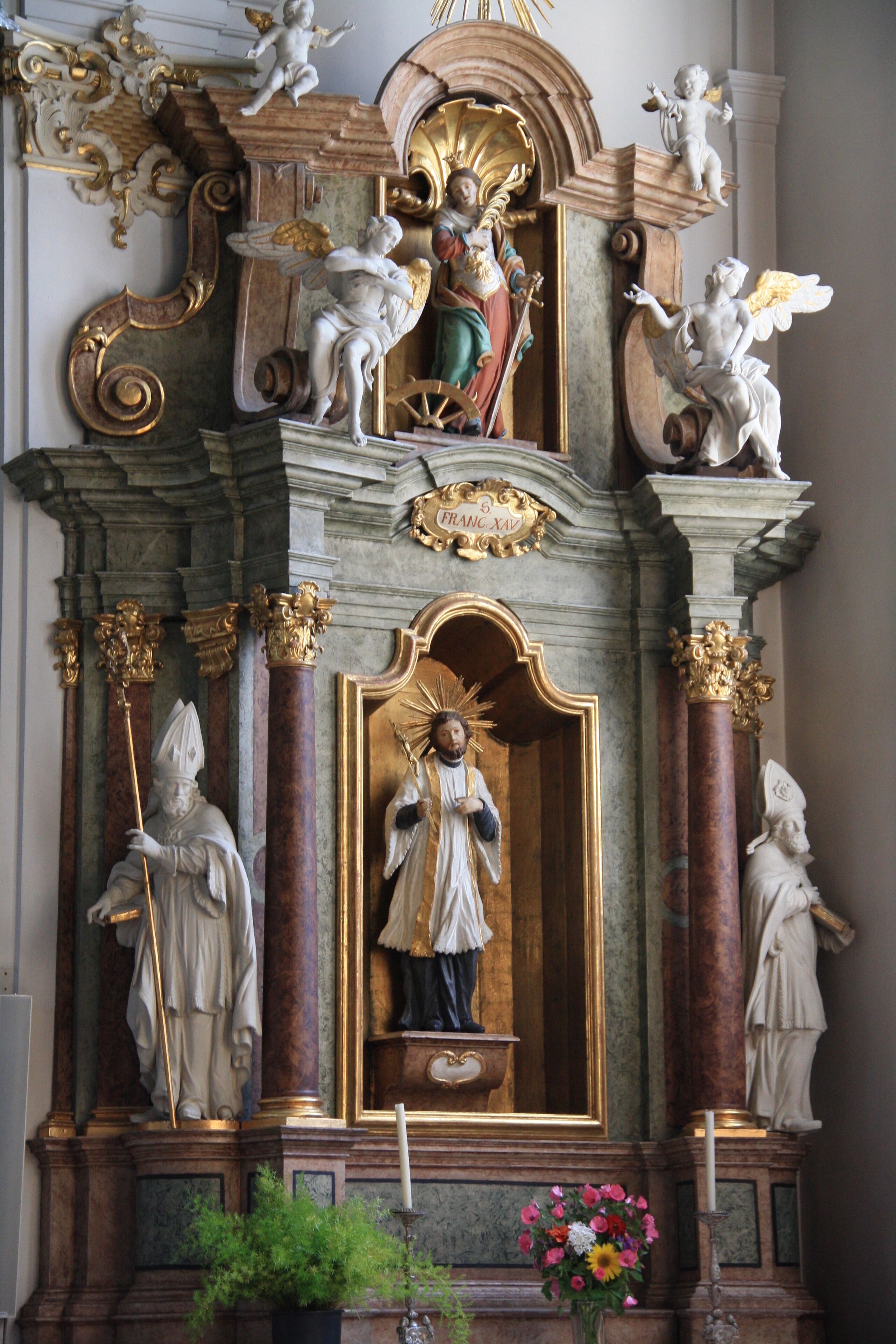 Italy, South Tyrol, Gossensaß. The church is dedicated to the Immaculate Conception and was built in 1750 on the same place of the old gothic church erected in 1471 and dedicated to Saint George of which remains the bell tower. The church was built on design of Franz de Paula Penz in baroque, it is possible a former project by Johann G. D. Grasmair. The church was consecrated on July 4 and 5, 1754 by bishop Leopold von Spaur. The front shows the portal of the old church and the three niches in which are placed the statues of the Immaculate Conception, Joachim and Saint Anne. The nave has a cross shape with two arms forming four lateral chapels. The high altar is rich in golden shades and at the centre of the throne is placed the statute of the Immaculate with the child was installed on April 23, 1752 by Josepf Stapf. The four statues are: St. George, St. Stephen, St. Lawrence and St. Florien. To the left side, between the two lateral chapels, is the baroque pulpit of 1777 positioned in a central site. To the right side between the two lateral chapels is a Crucifix by Bartlmä Kleinhans. The first right lateral altar is dedicated to Our Lady of Sorrows encircled by the statues of Mary Magdalene, Saint Elisabeth and Saint James works of 1750. The second right lateral altar is dedicated to Francis Xavier and two Bishops: Saint Ingenuinus and Saint Albuin coming from the old Saint George church. The first left lateral altar is the Flagellation of Christ at the column and the Saints Peter and John on each side. To the second left lateral altar is Saint Leonard, by side are the statues of Saint Sylvester, Saint Gregory and Saint Barbara coming from the old church. The eastern dome fresco was painted by Matthäus Günther and represents the Christ crowning Mary and Saint George throwing the pierced dragon downwards.