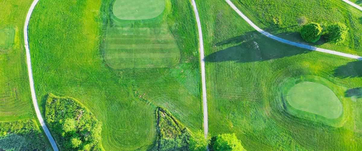 Straight aerial view cart path in 18 holes golf course, lavish greens sloping fairways, lots of trees at municipal country club in Mountain Grove, Missouri, scenic grassy lawn meadow laid back
