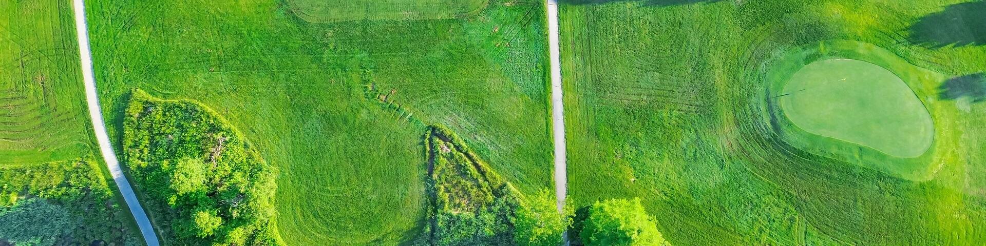 Straight aerial view cart path in 18 holes golf course, lavish greens sloping fairways, lots of trees at municipal country club in Mountain Grove, Missouri, scenic grassy lawn meadow laid back