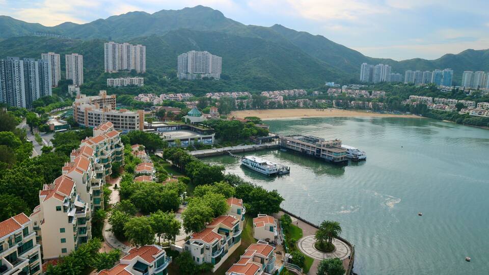 A river with boats, a bridge, and buildings along the shore.