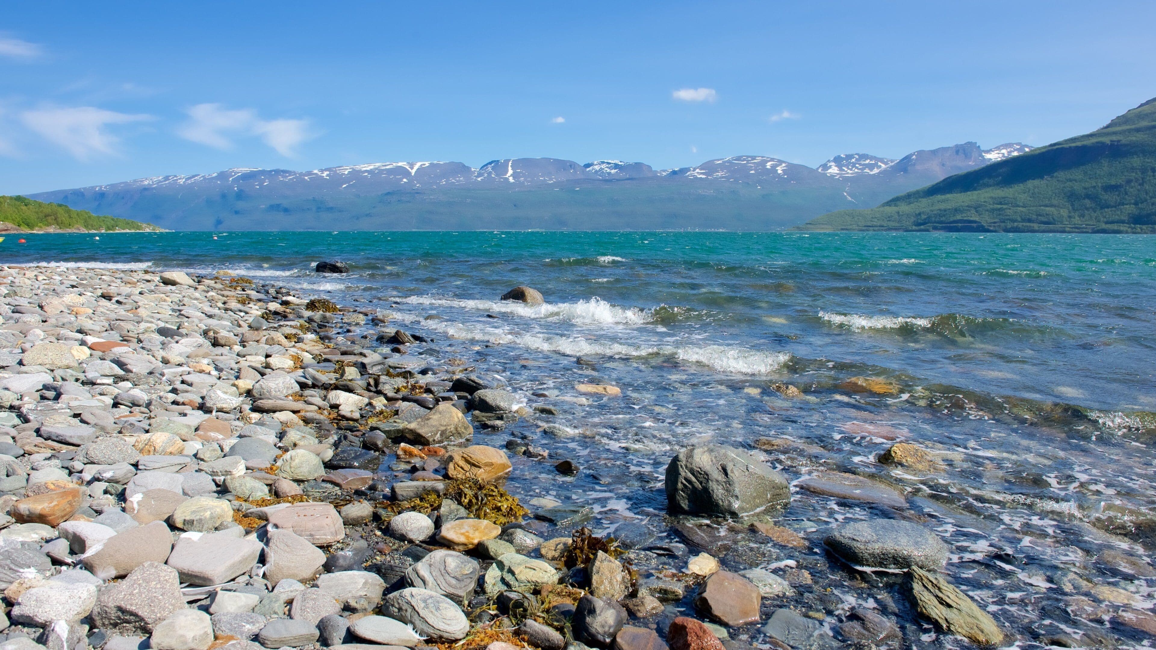 Storfjord which includes mountains, a pebble beach and a lake or waterhole